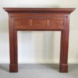 A large early 20th century carved wooden fire surround,