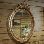 A gilt framed oval wall mirror,