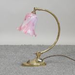 A Christopher Wray brass desk lamp, with a pink shade,
