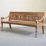 A fruit wood bench, with a carved back, on turned legs,