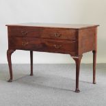 An early 20th century mahogany chest, on turned legs and pad feet,