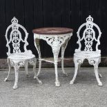 A painted metal garden table and two chairs