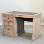 A pine single pedestal desk, with a black inset writing surface,