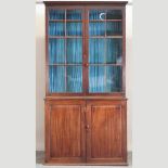 An early 19th century mahogany cabinet bookcase, of large proportions,