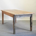 A rustic pine kitchen table, on square tapered legs,