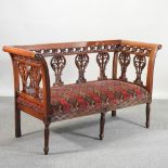 An antique style show frame sofa, with red geometric upholstery, retailed by Harrods,