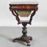 A Victorian rosewood ladies work table, on a tripod base,