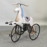 A vintage child's tricycle in the form of a horse,