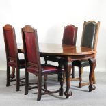 A 1920's oval wind-out dining table, on claw and ball feet, with an additional leaf, 186 x 115cm,