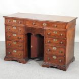 A 19th century mahogany kneehole desk, on bracket feet,