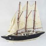 A painted wooden model of a sailing ship, 68cm long,
