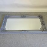 A grey painted wall mirror,