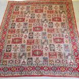 A late 20th century woollen carpet, with geometric design, on a red ground,