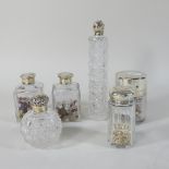 A pair of early 20th century glass scent bottles, with silver covers, 8cm high,