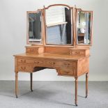 An antique pine dressing table, on turned legs,