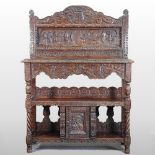 A Victorian carved oak buffet, decorated in relief with William the Conqueror and dated 1598,