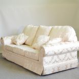 A modern cream damask upholstered four piece suite, comprising a sofa,