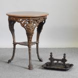 A cast iron circular table, with a laminated top, 61cm diameter,