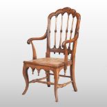 A Victorian Gothic style fruitwood armchair,