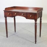 A Regency mahogany and crossbanded washstand, containing three drawers, on turned legs,
