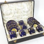 A set of six Cauldon blue and gilt coffee cans, in a fitted case,
