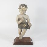 A late 17th century style polychrome painted cherub, mounted on a plinth base,