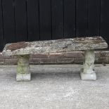 A reconstituted stone garden bench, on lion and squirrel supports,