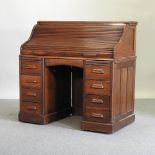 A 1920's oak tambour fronted pedestal desk,