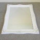 A white painted wall mirror,