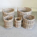 A set of five circular graduated wicker log baskets,