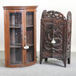 An early 20th century oriental carved oak side cabinet, relief decorated with a dragon, 72cm,