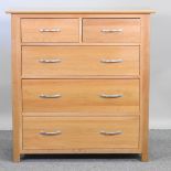 A modern light oak chest of drawers,