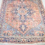 A Turkish woollen rug, with geometric design and a central medallion, on a red ground,