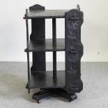 An Edwardian carved dark revolving bookcase,