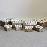 A set of four graduated wicker baskets, with stag print liners, largest 48cm,