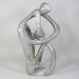 An abstract soapstone carving, of a mother and child,