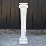 A marbled reconstituted stone garden pedestal, in the form of an Ionic column,