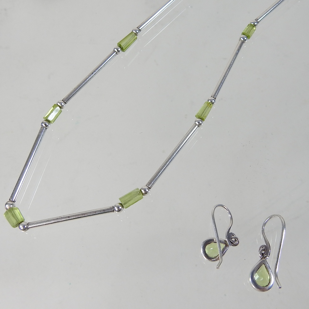 A silver and peridot necklace, together with a pair of matching earrings,
