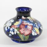 An early 20th century Moorcroft pottery vase, of squat shape, decorated with flowers,