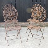 A set of four folding metal garden chairs