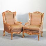 A pair of French style gilt framed and brown upholstered wingback armchairs