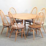 An Ercol light elm drop leaf dining table, 112 x 124cm overall,
