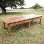 A large 19th century elm kitchen table, on a pine stretcher base, containing two drawers,