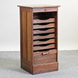 An early 20th century mahogany filing cabinet, with a tambour front, bearing a label for Crusader,