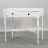 A cream painted side table,