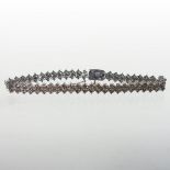 A 9 carat gold champagne diamond line bracelet, set with three rows of stones, approximately 6.