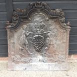 An 18th century style cast iron fire back, with relief decoration,