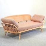 An Ercol light elm three seater studio couch, with loose cushions,
