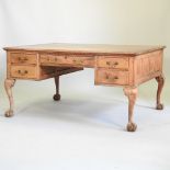 An early 20th century oak partners desk, on cabriole legs, and claw and ball feet, 152cm,