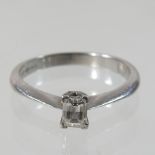 A modern platinum and diamond baguette cut single stone diamond ring, approximately 0.